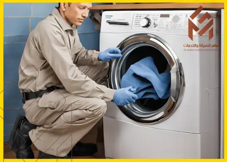 فني يرتدي زي عمل يقوم بوضع منشفة زرقاء في غسالة تحت شعار "الماهر للصيانة والخدمات".